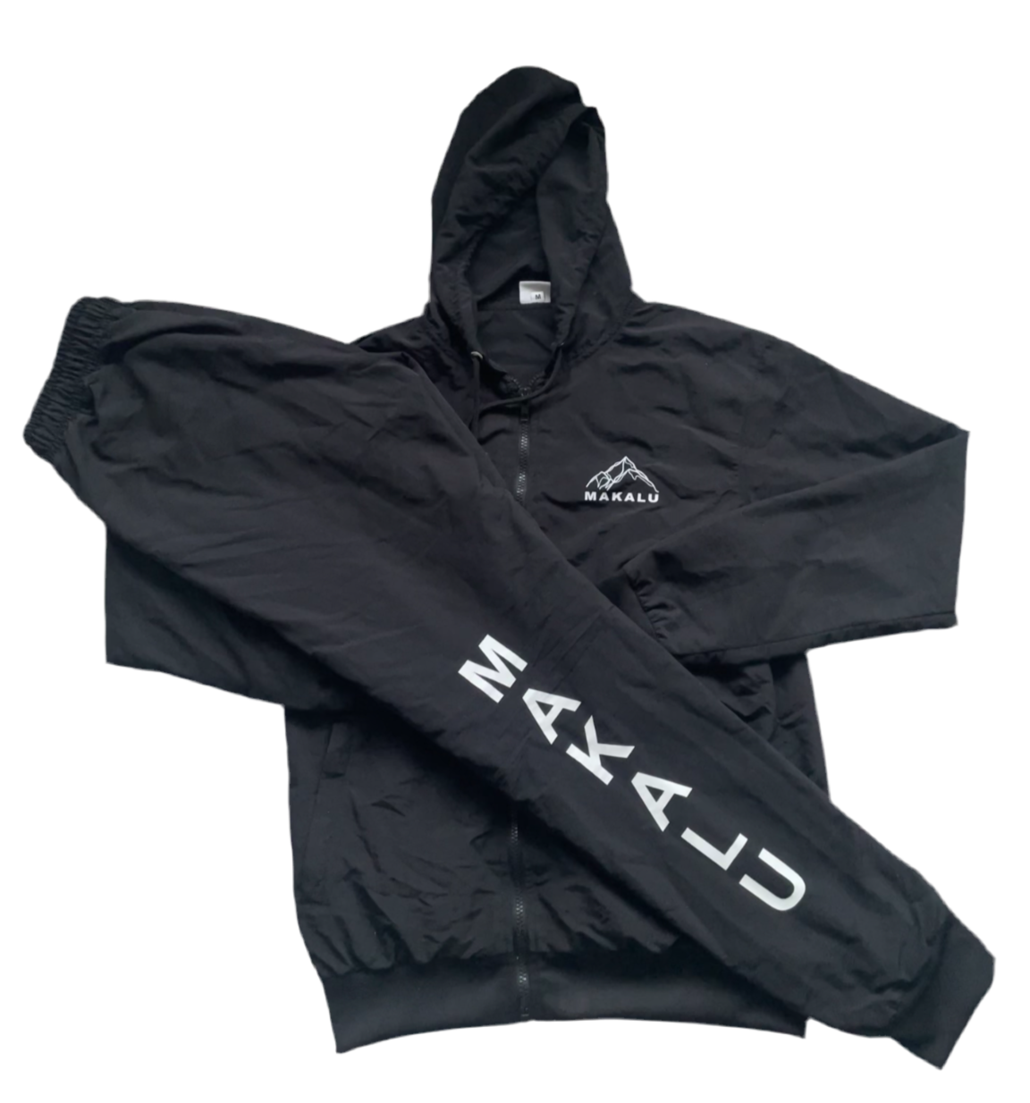 Black nylon Makalu tracksuit with hooded jacket and elastic waist pants featuring Makalu logo on chest and leg.